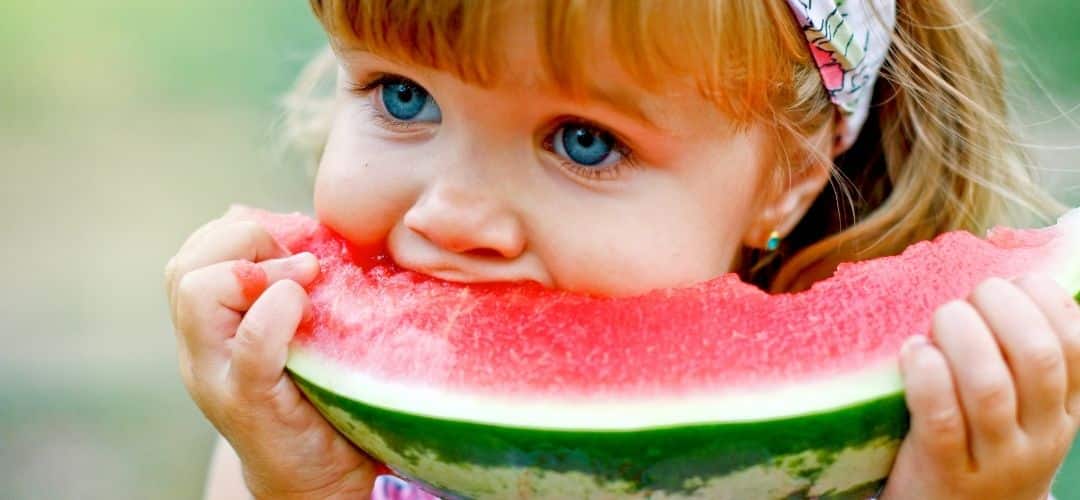 Niña comiendo fruta